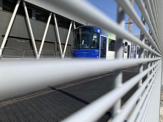 A blue and white tram at the new tl Perrelet tram depot.