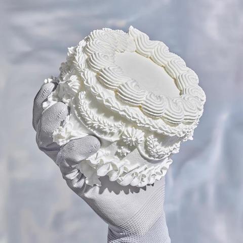 Album cover of “IJsland 2” by Abel & Sef, showing a hand in a white glove holding a cream cake.