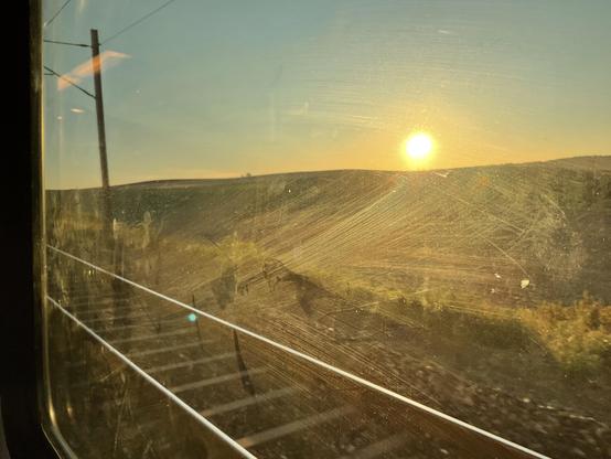Sunrise seen through a train window.